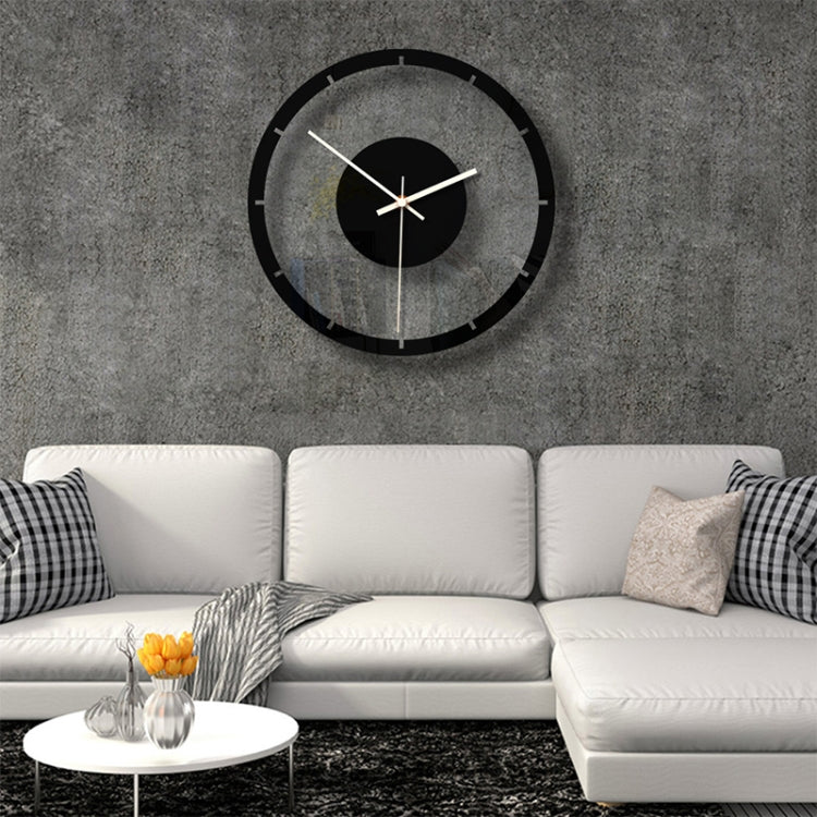 Round wall clock with black outer ring, clear face, black center disc, gold hands