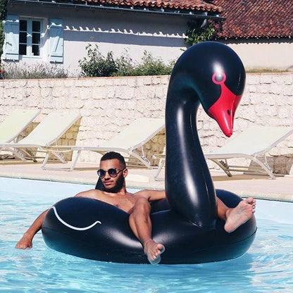 Inflatable black swan-shaped swimming pool ring with red beak, curved wings