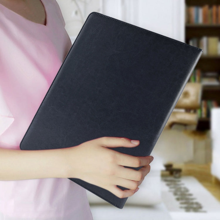 Black leather document folder being held in hand, front cover closed