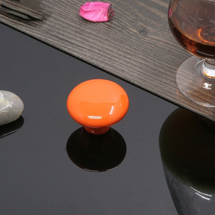 Glazed ceramic cabinet drawer handle with orange knob and black base