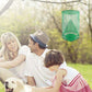 Hanging green mesh fly cage near people and a dog outdoors
