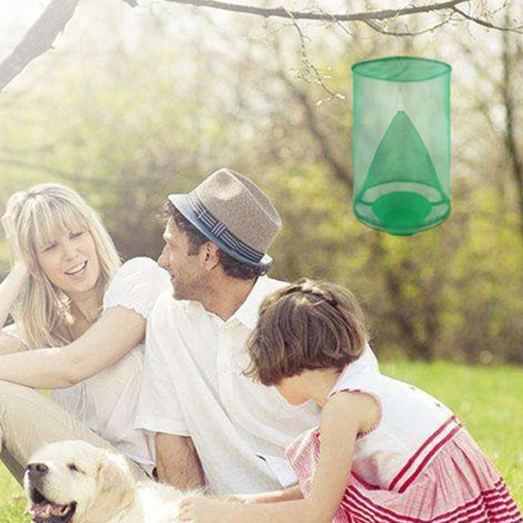 Hanging green mesh fly cage near people and a dog outdoors
