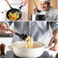 Chef using silicone spaghetti utensil with wooden handle over boiling pot