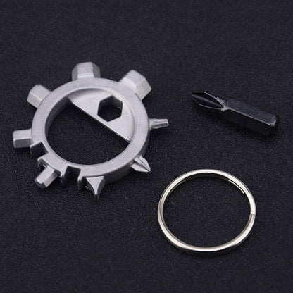 Silver gear-style keychain tool with loop ring and black screwdriver bit tool