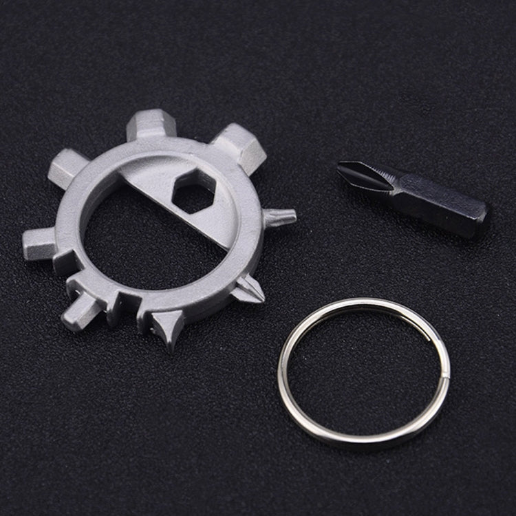 Silver circular gear tool with loop ring and black screwdriver bit