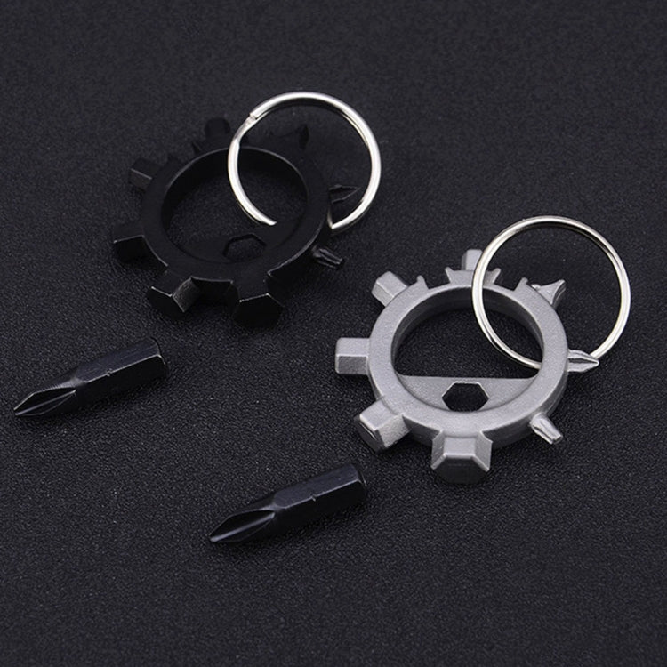 Two gear-style keychain tools (black and silver) with loop rings and screwdriver bits