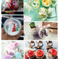 Assorted clear hanging ball ornaments with bows, flowers, and gift-ready accessories
