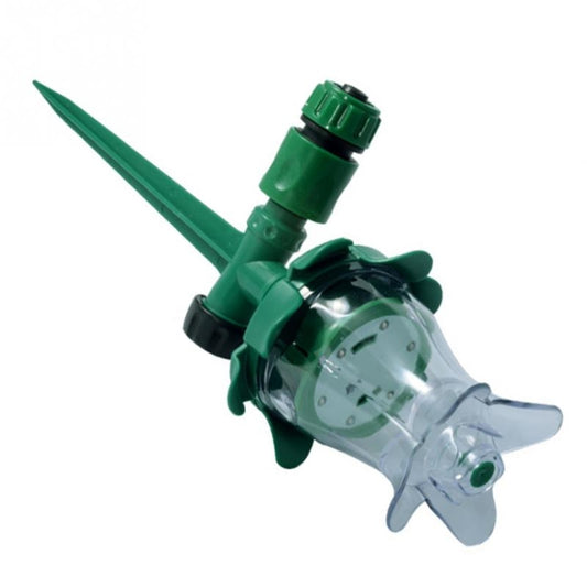 Close-up LED sprinkler head with green arm, clear chamber, and ground stake