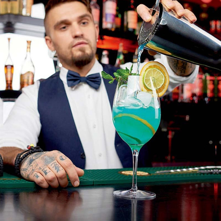 Cocktail shaker bottle pouring into a glass at a bar using an 18-in-1 set