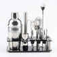 Cocktail shaker tools set with stainless strainer and jigger pieces on black acrylic tray