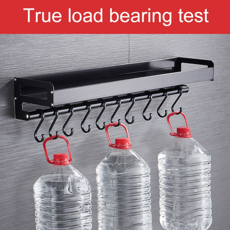 Black kitchen rack hook row holding water jugs on six curved hooks