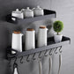 Black wall hanging spice rack with two tier shelves, canisters, and six hooks