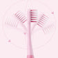 Pink children soft toothbrush with angled bristle heads in heart-shaped layout