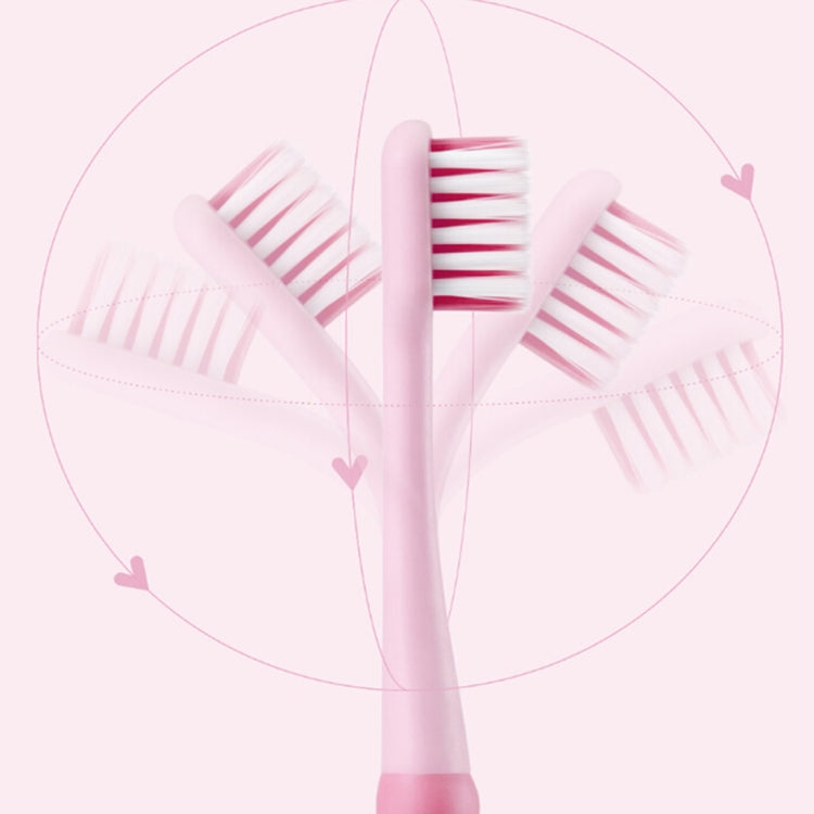 Pink children soft toothbrush with angled bristle heads in heart-shaped layout