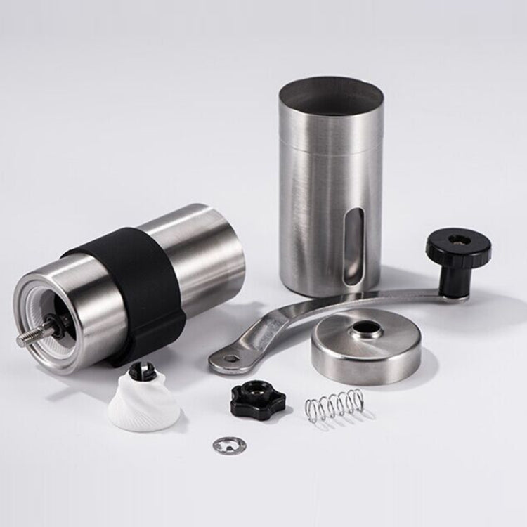 Manual coffee bean grinder in stainless steel with black silicone ring and crank knob; parts shown