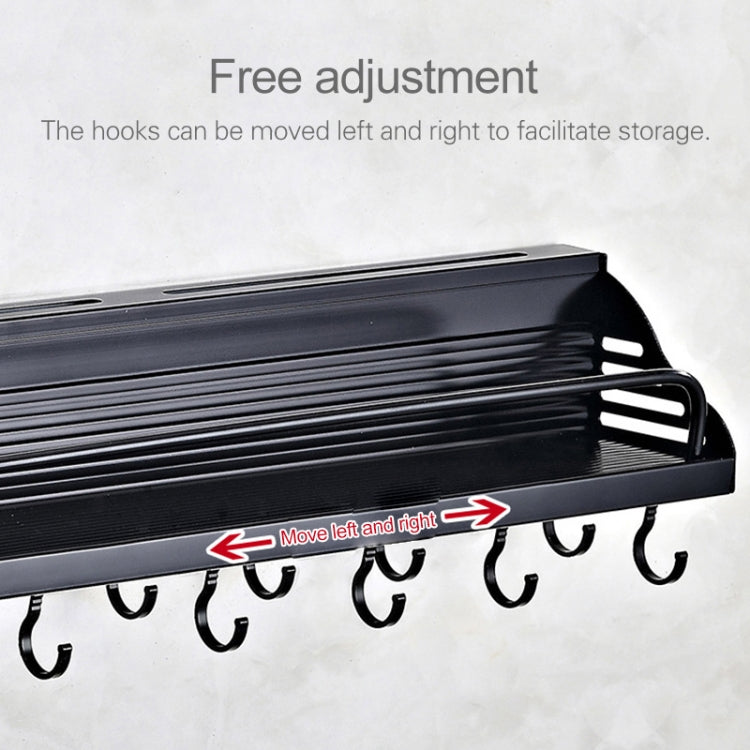 Black wall rack with adjustable hooks along the underside support bar