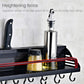 Black condiment rack with raised guard rail holding bottles and kitchen tools