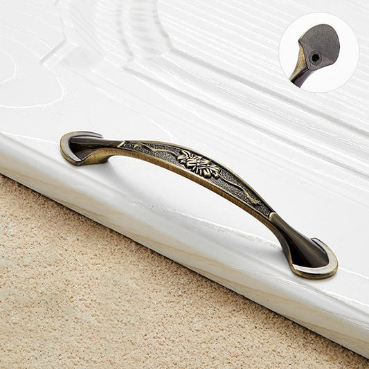 Bronze cabinet drawer handle with decorative center inlay and curved ends