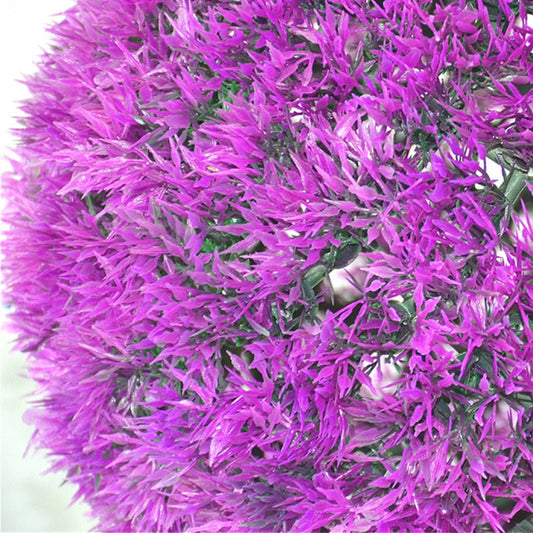 Close-up of purple artificial grass strands on a topiary ball, dense texture