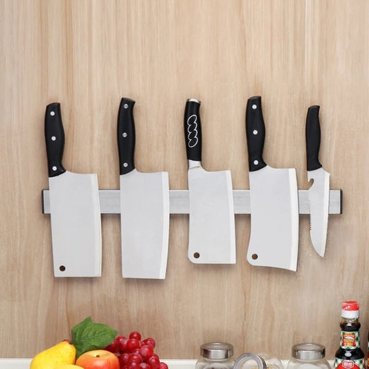 Wall-mounted magnetic knife holder with stainless rail and six knives, white mounting panels
