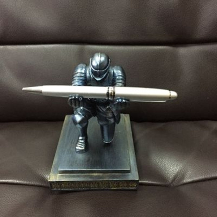 Knight-themed desktop pen holder with silver figurine and white pen