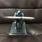 Silver armored knight desktop pen holder holding a white pen