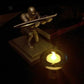 Gold-tone knight desktop pen holder with pen resting on a base