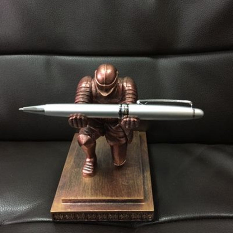 Bronze knight desktop pen holder with white pen on a wooden-toned base