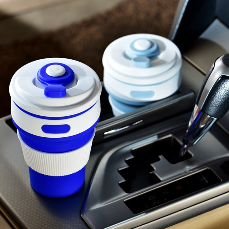 Blue folding silicone coffee cup in car console with snap lid, 350ml travel cup