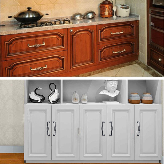 Birdcage-style handle on wooden cabinet drawer front, matte black with cage loop.