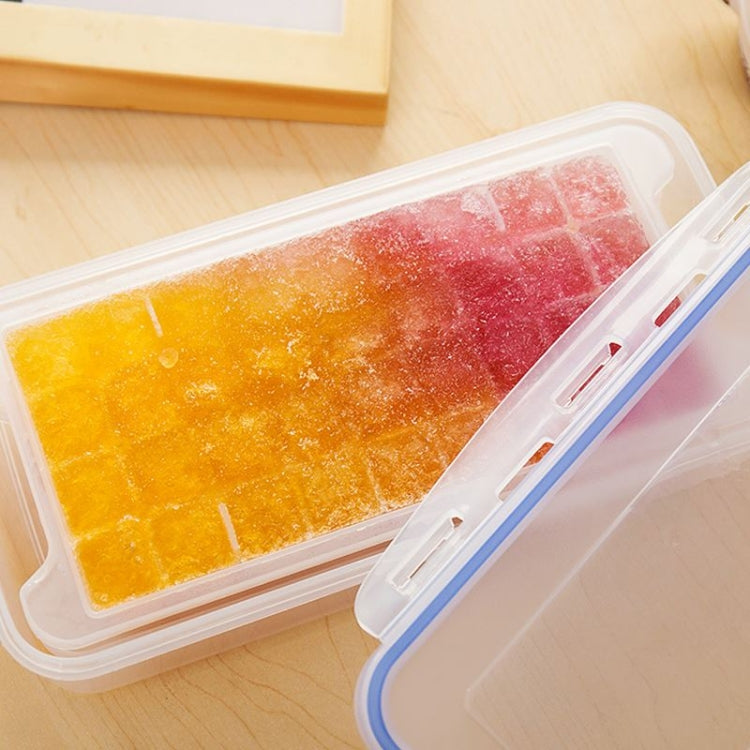 Square ice trays with pink, red, and orange cubes in clear sealed storage box