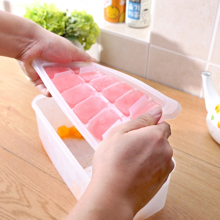 Hands placing pink square ice tray into clear storage container with lid