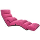 Foldable single recliner floor chair in pink, padded backrest and cushioned footrest