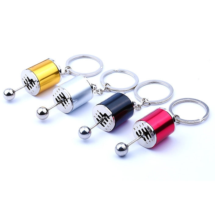 Assorted gear shift keychains in gold, silver, blue, red, black, and others with rings