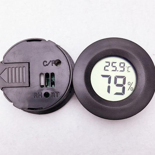 Round digital thermometer hygrometer with display reading 25.9°C and 19% humidity