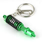 Green shock absorber keychain key ring with black spring coil and metal clip