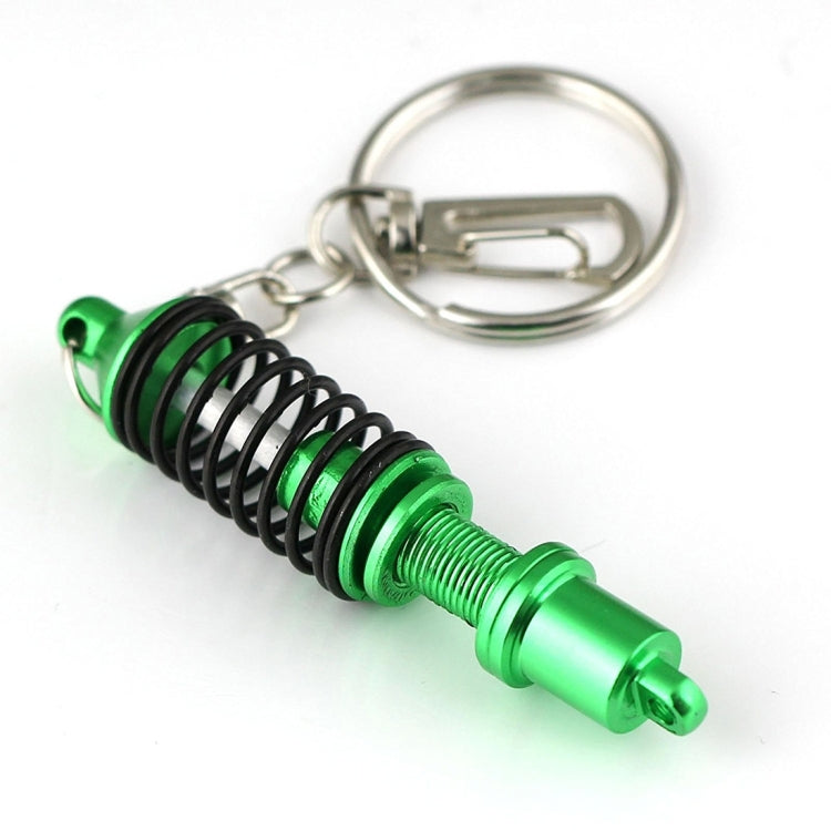 Green shock absorber keychain key ring with black spring coil and metal clip