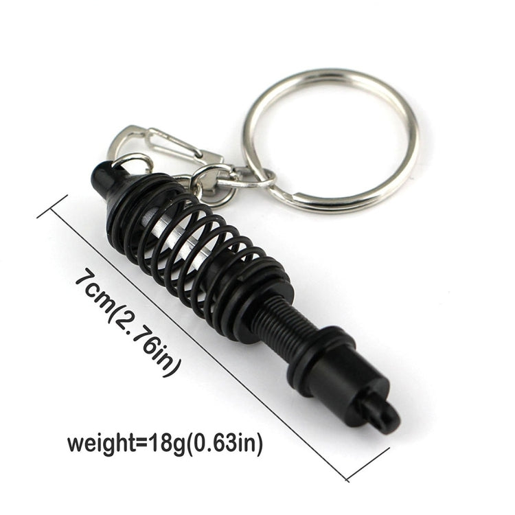 Black shock absorber keychain with silver key ring and spring detail