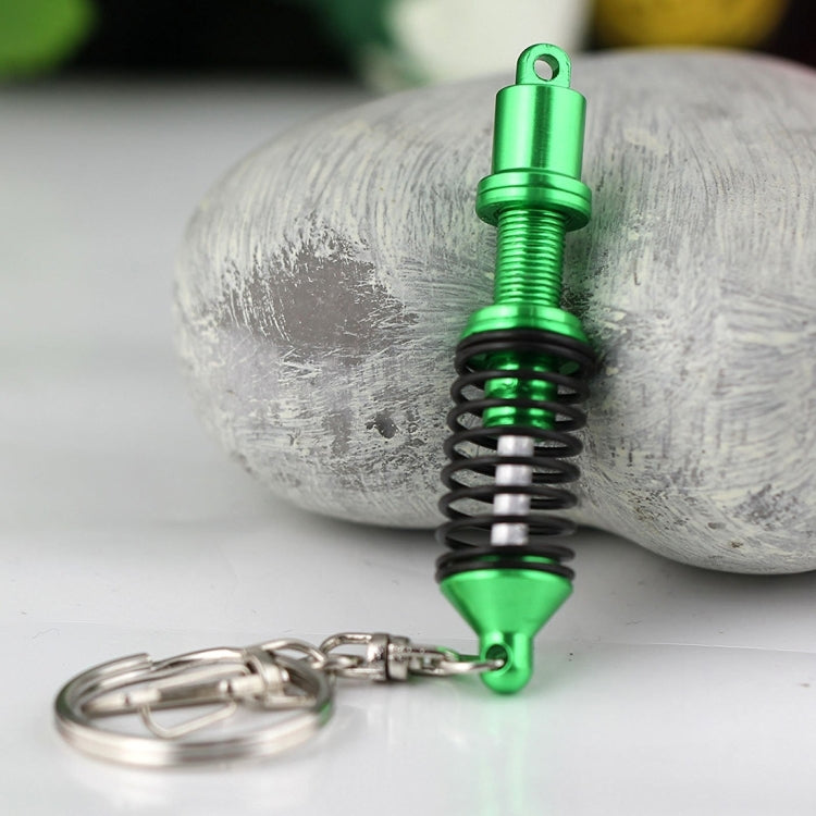 Green shock absorber keychain with black spring and silver key ring