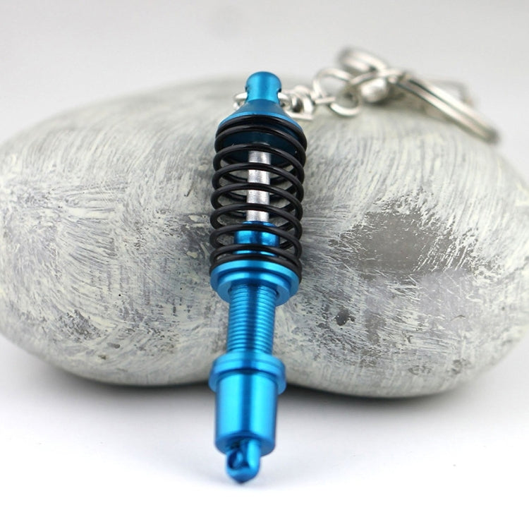 Blue shock absorber keychain with black spring coil and silver key ring