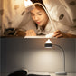 Cat-shaped LED desk lamp with curved neck, lit glow on bedside table