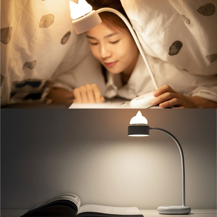 Cat-shaped LED desk lamp with curved neck, lit glow on bedside table