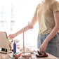 Cat-shaped LED desk lamp with white cord, set on desk during use