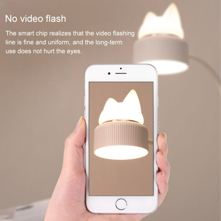 Cat LED night lamp glowing beside a smartphone showing the lit lamp