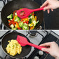 Red silicone kitchen tool set in skillet and on stove, held by hands