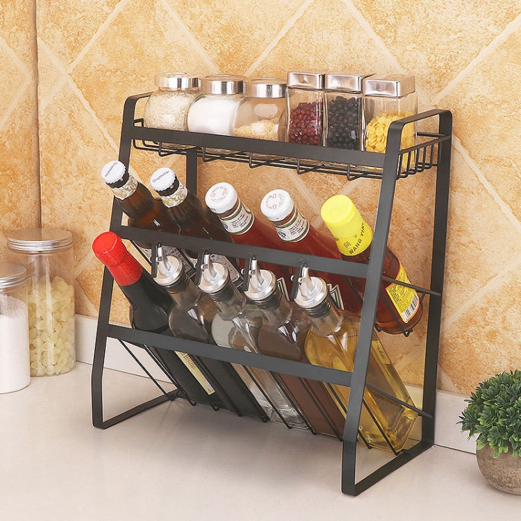 Three-tier black metal spice rack with wire shelves and bottle holders