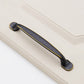 Black bar drawer handle with curved ends and gold border accents