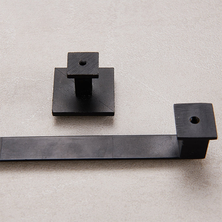 Black drawer handle mounting bases with central pin posts on a board