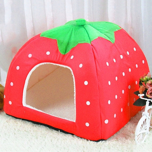 Red strawberry-shaped plush pet house with green leaf top and front opening
