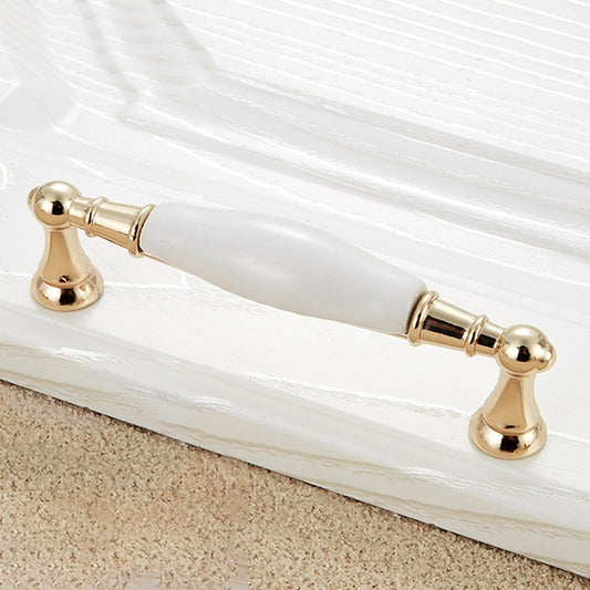 Gold ceramic cabinet drawer pull with white center bar and round end mounts